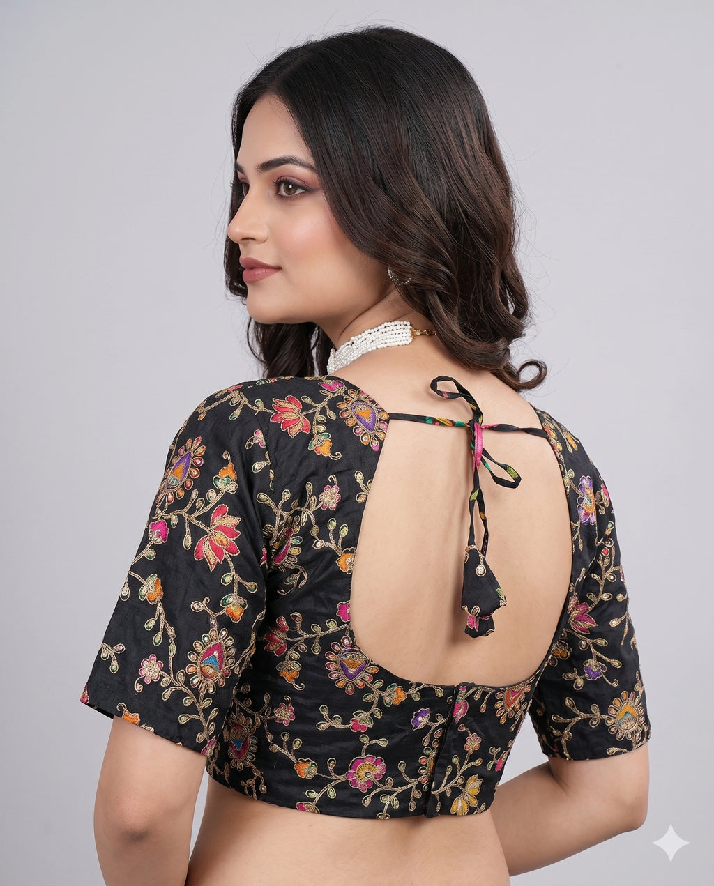 Black embroidered saree blouse front view model smiling